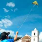 kid enjoying a sunny day flying a kite in Colombia.