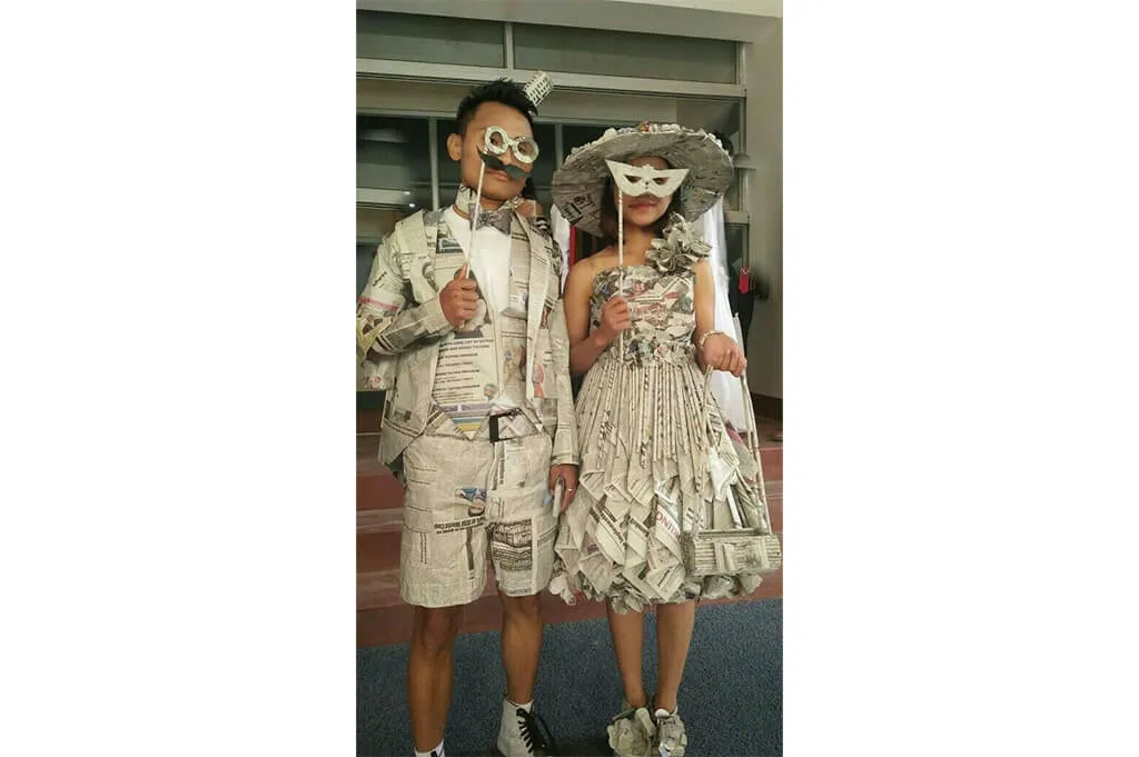 Vintage newspaper costumes with pleated dress and wide-brim hat—recycled Halloween look